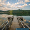 A dock opens up to a beautiful lake enclosed by West Virginia mountains.