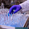 Chemours Belle Plant. A gloved hand carefully grabs some glassware.