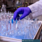 Chemours Belle Plant. A gloved hand carefully grabs some glassware.