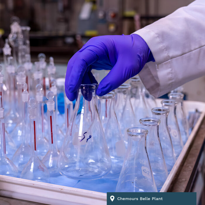 Chemours Belle Plant. A gloved hand carefully grabs some glassware.
