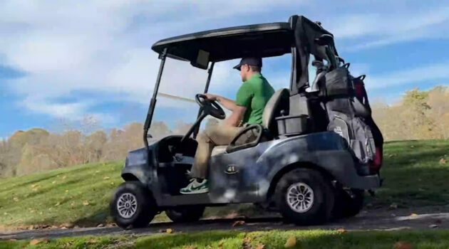 A man in a golf cart at Stonewall Resort State Park