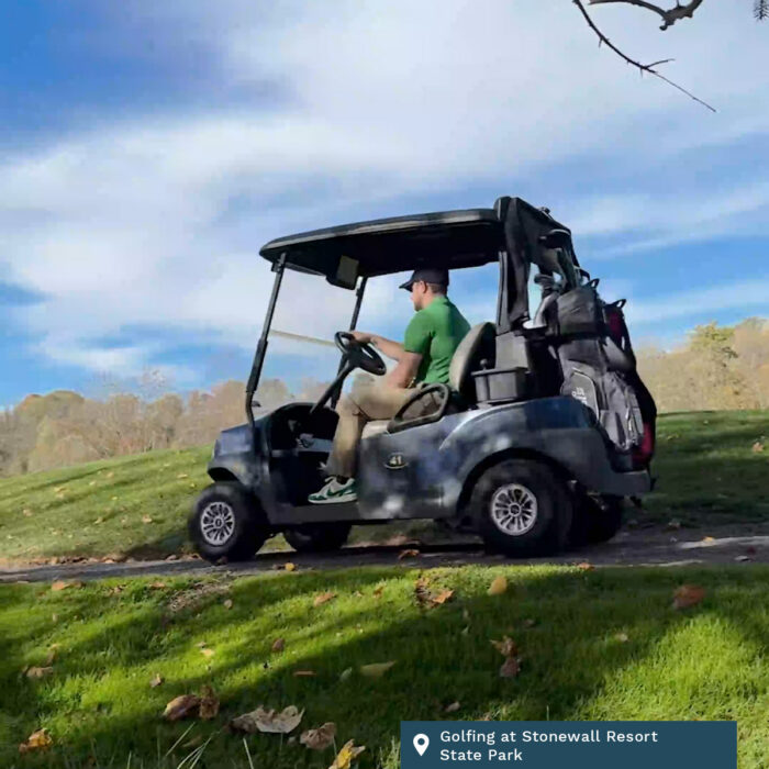 A man in a golf cart at Stonewall Resort State Park