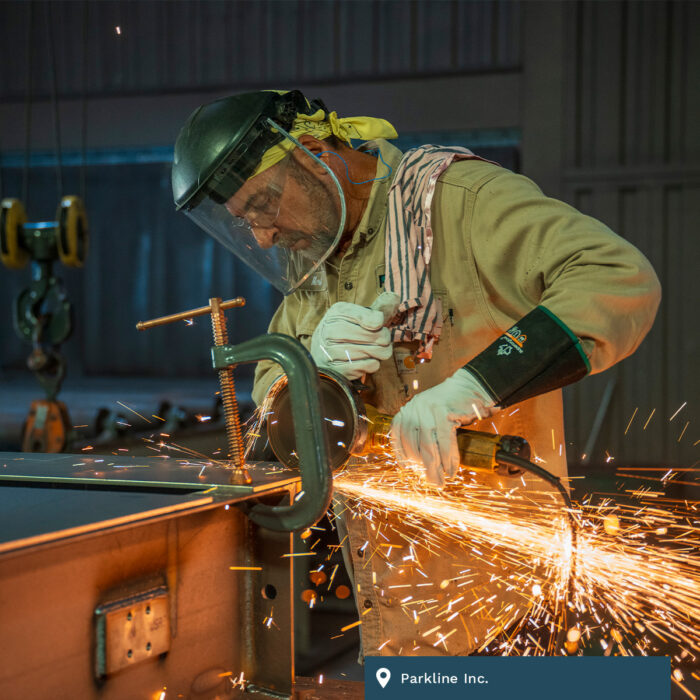 A worker grinds metal at Parkline Inc.