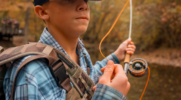 A young man trout fishes in West Virginia